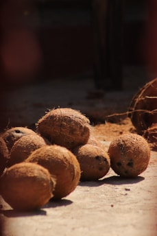 a pile of coconuts sitting on top of a wooden table