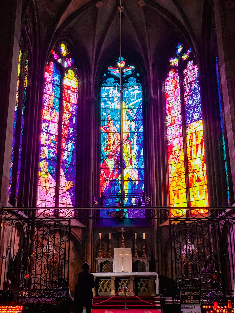 a man standing in front of a stained glass window