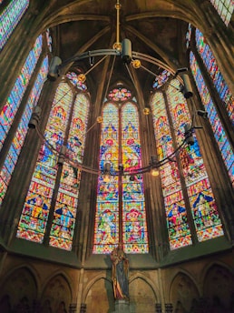 a large stained glass window inside of a church