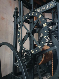 An elegant mechanical model of a clockwork device with visible gears and brass details.