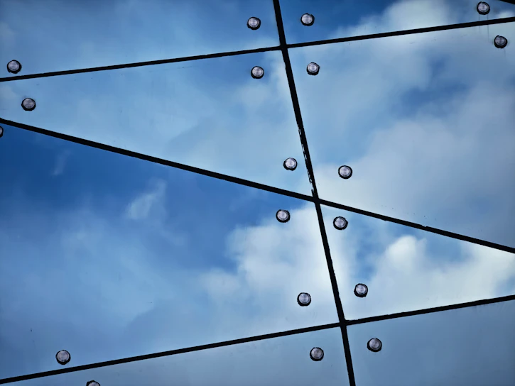 Hexagonal pattern overlay on rugged mining equipment under a deep blue sky.