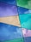 Colorful glass panels intersect with black lines, forming geometric shapes. Each panel displays vibrant shades of blue, purple, green, and yellow. Metallic rivets are visible at intersecting points, enhancing the modern and artistic appearance.