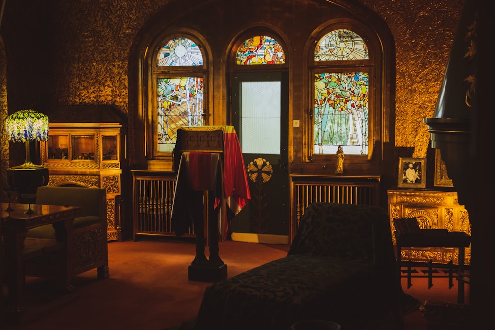 a room with stained glass windows and furniture