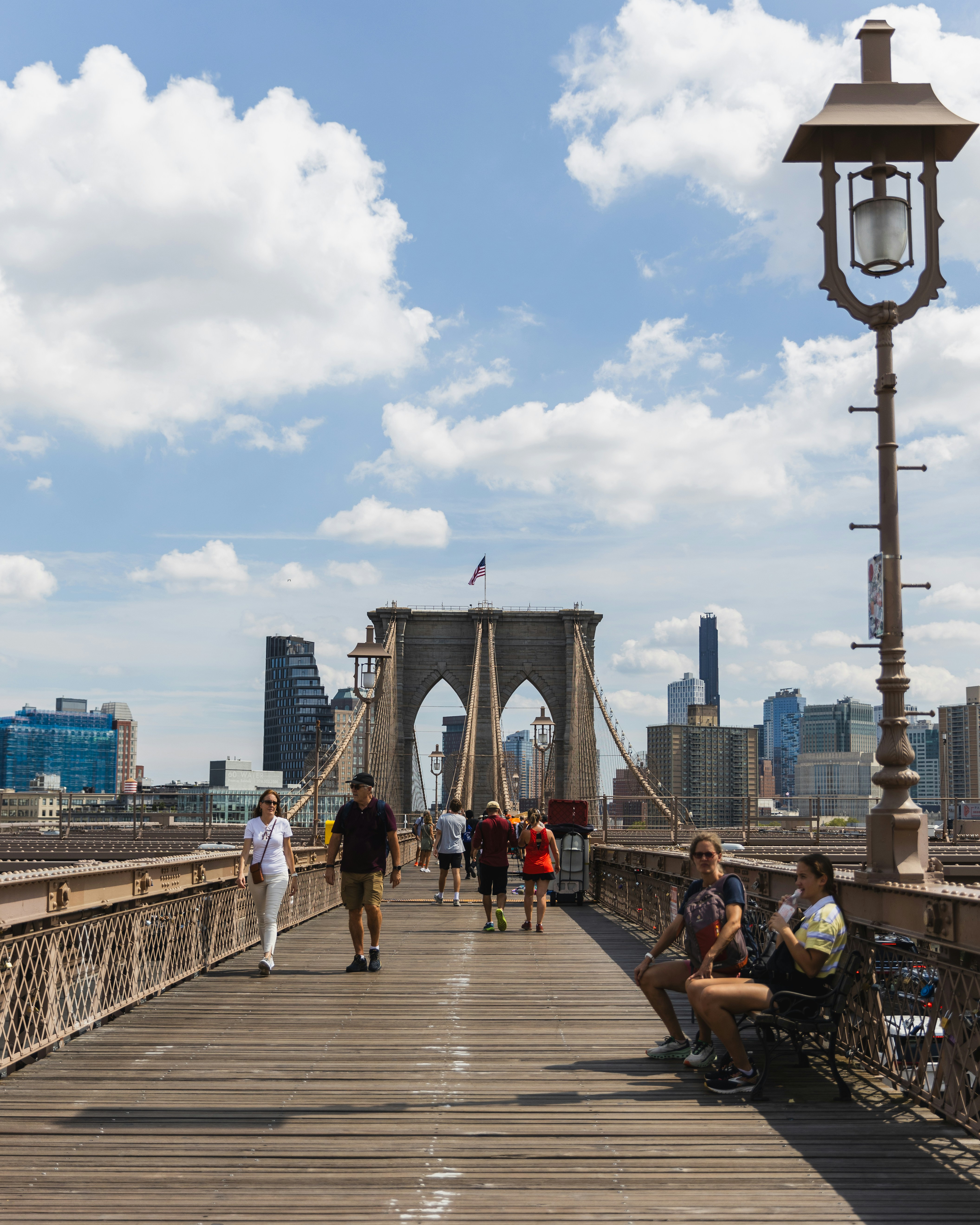 A group of people walking across a bridge photo – Free New york Image ...