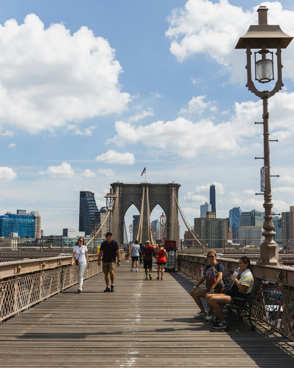 a group of people walking across a bridge