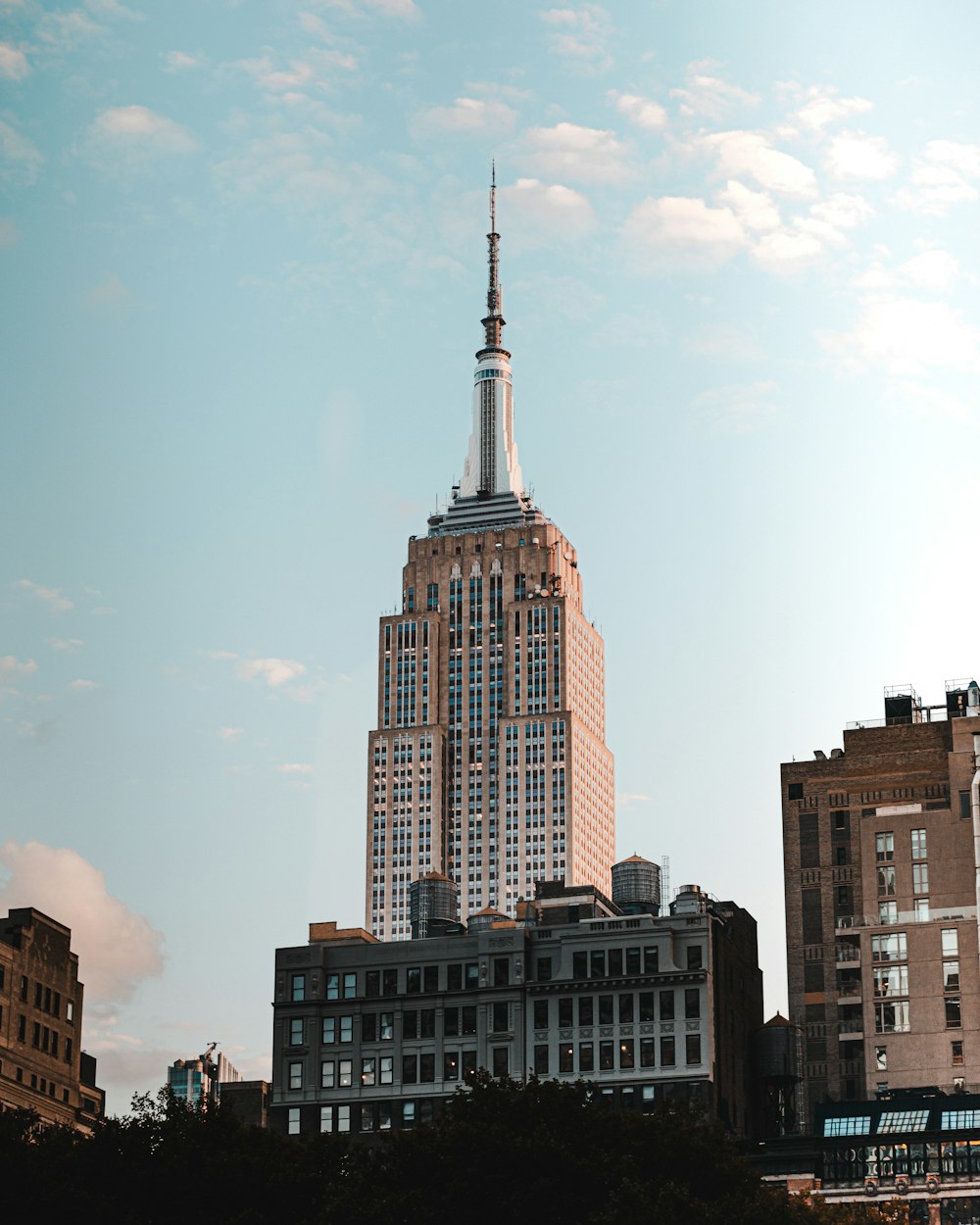 a tall building with a spire in the middle of a city