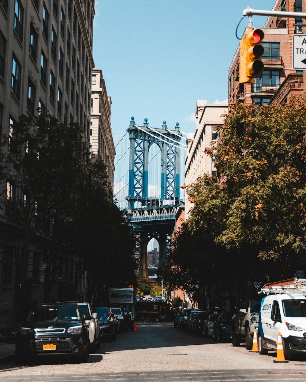 a city street with a bridge in the background