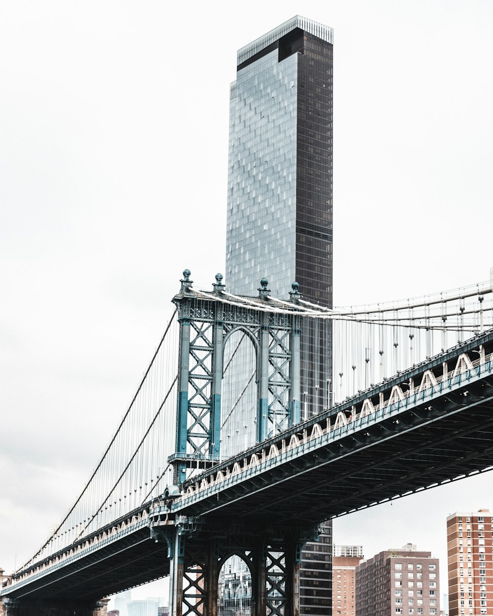 a large bridge with a tall building in the background