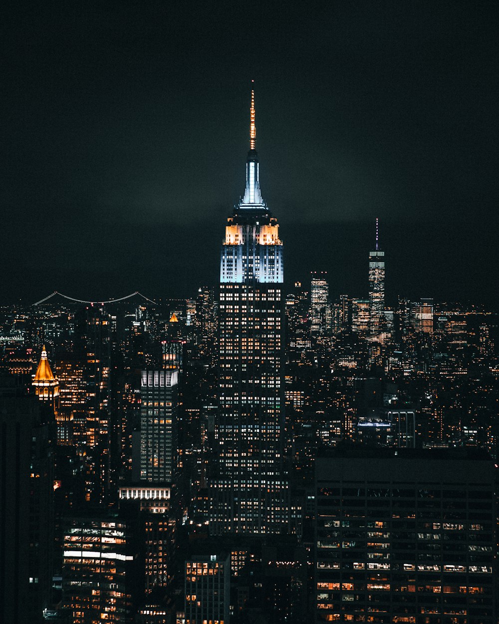 the empire building lit up at night in new york city