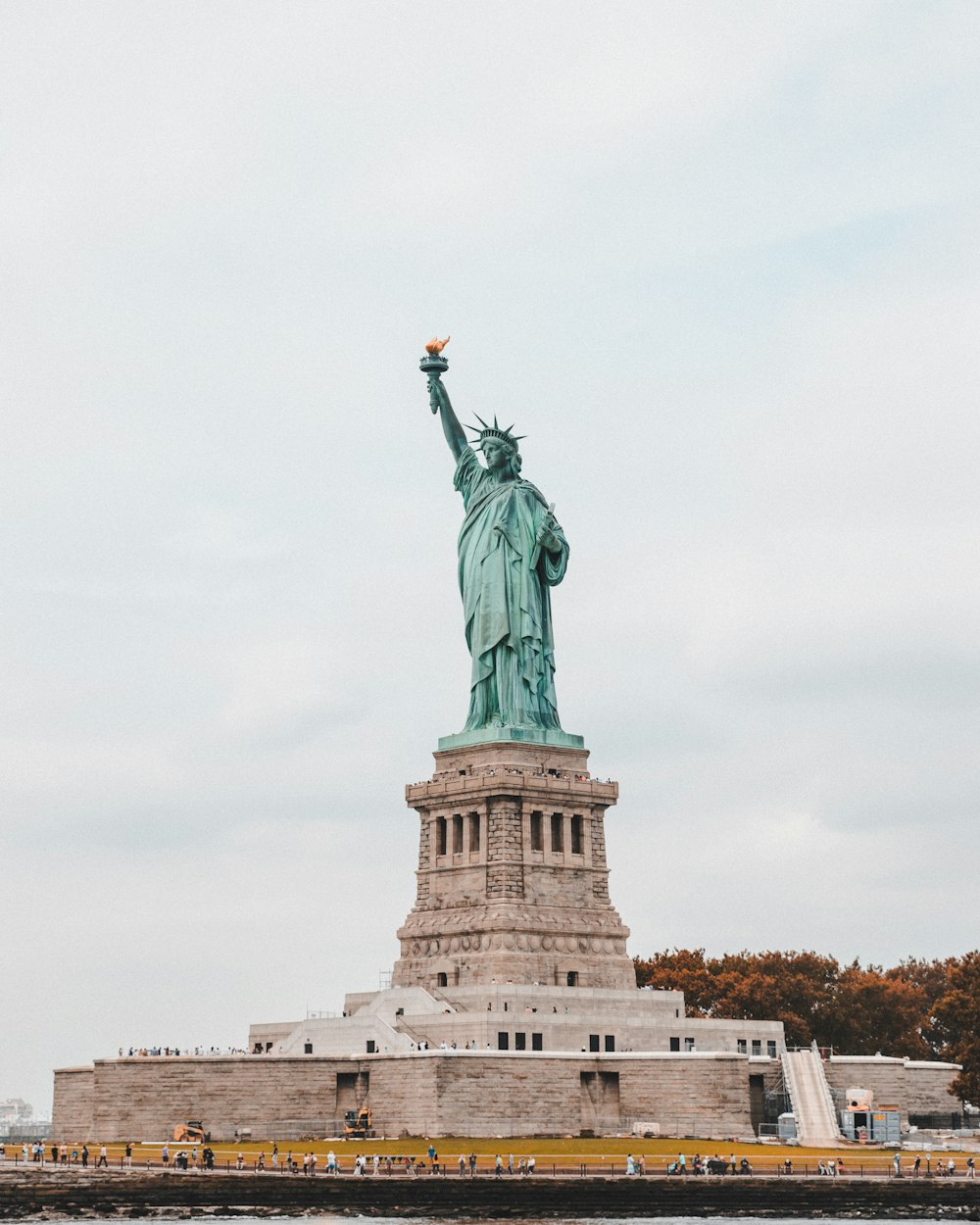 the statue of liberty is in the middle of a body of water