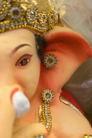 Close-up of a handcrafted jewel-art portrait of Lord Krishna, showcasing intricate beadwork and shimmering jewels.