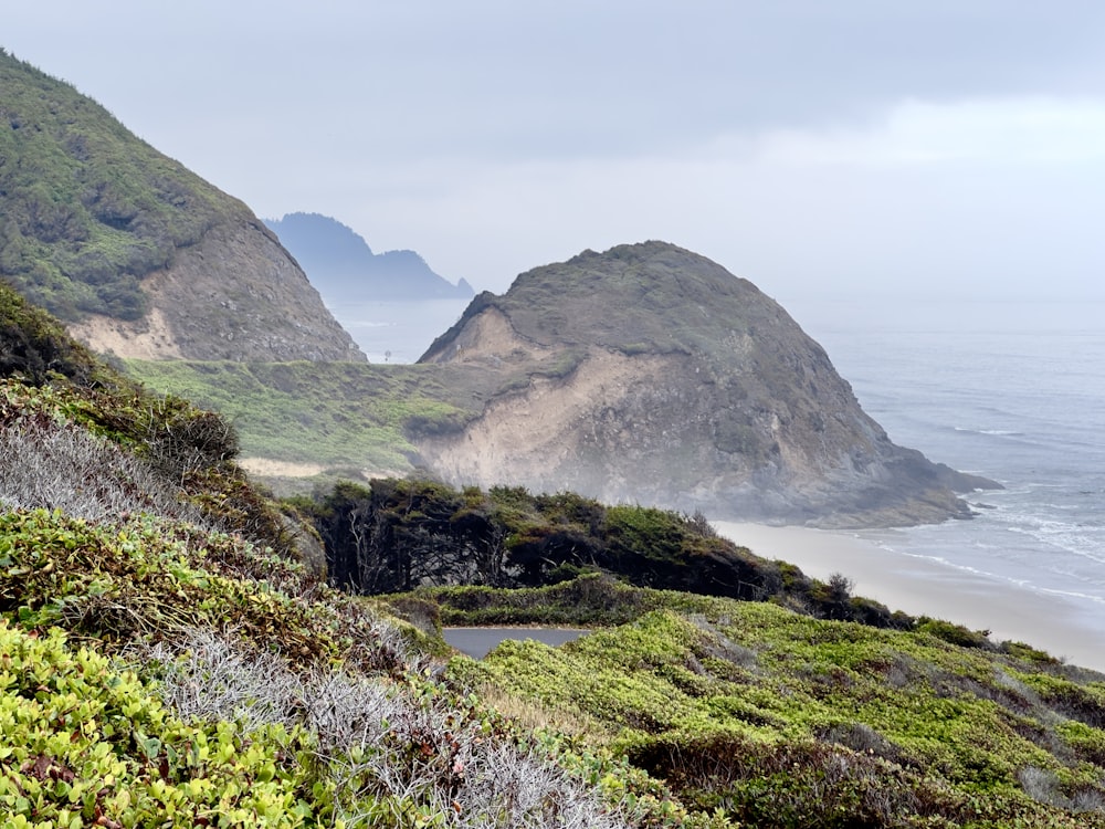 a scenic view of the ocean and mountains