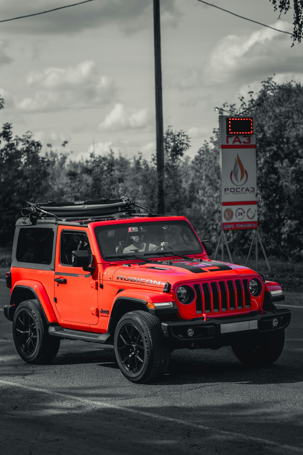 a red jeep parked in a parking lot