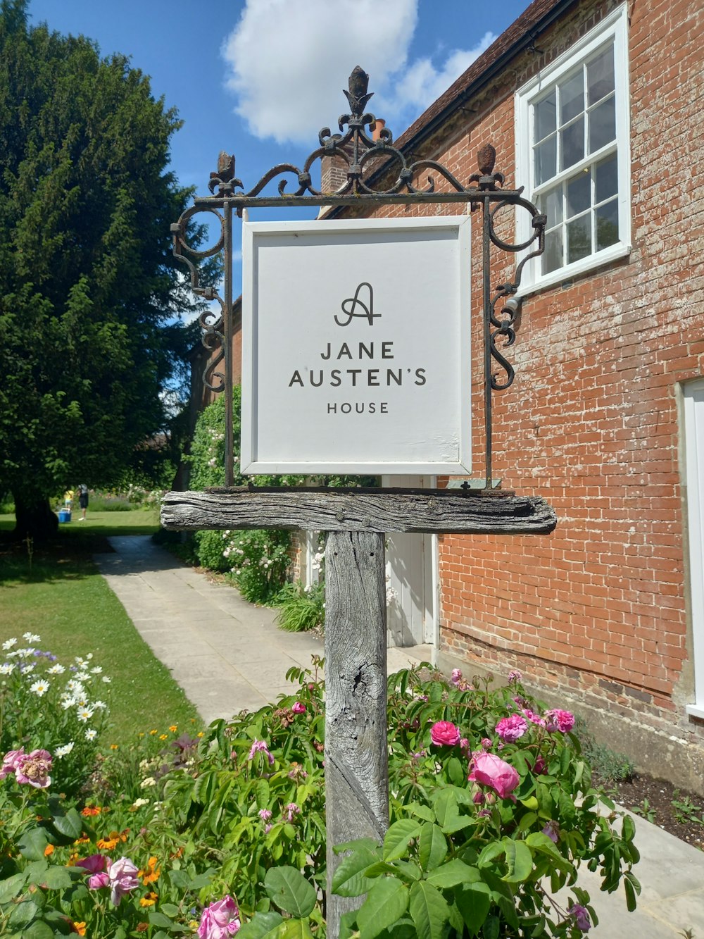 a sign in front of a brick building