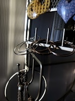 A variety of dangling earrings hanging on a rustic metal stand with soft lighting.