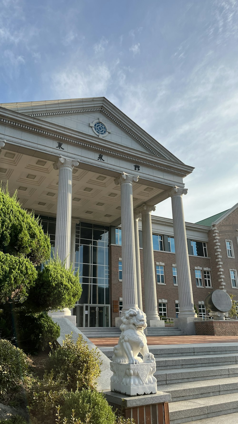 a building with columns and a clock on the front of it