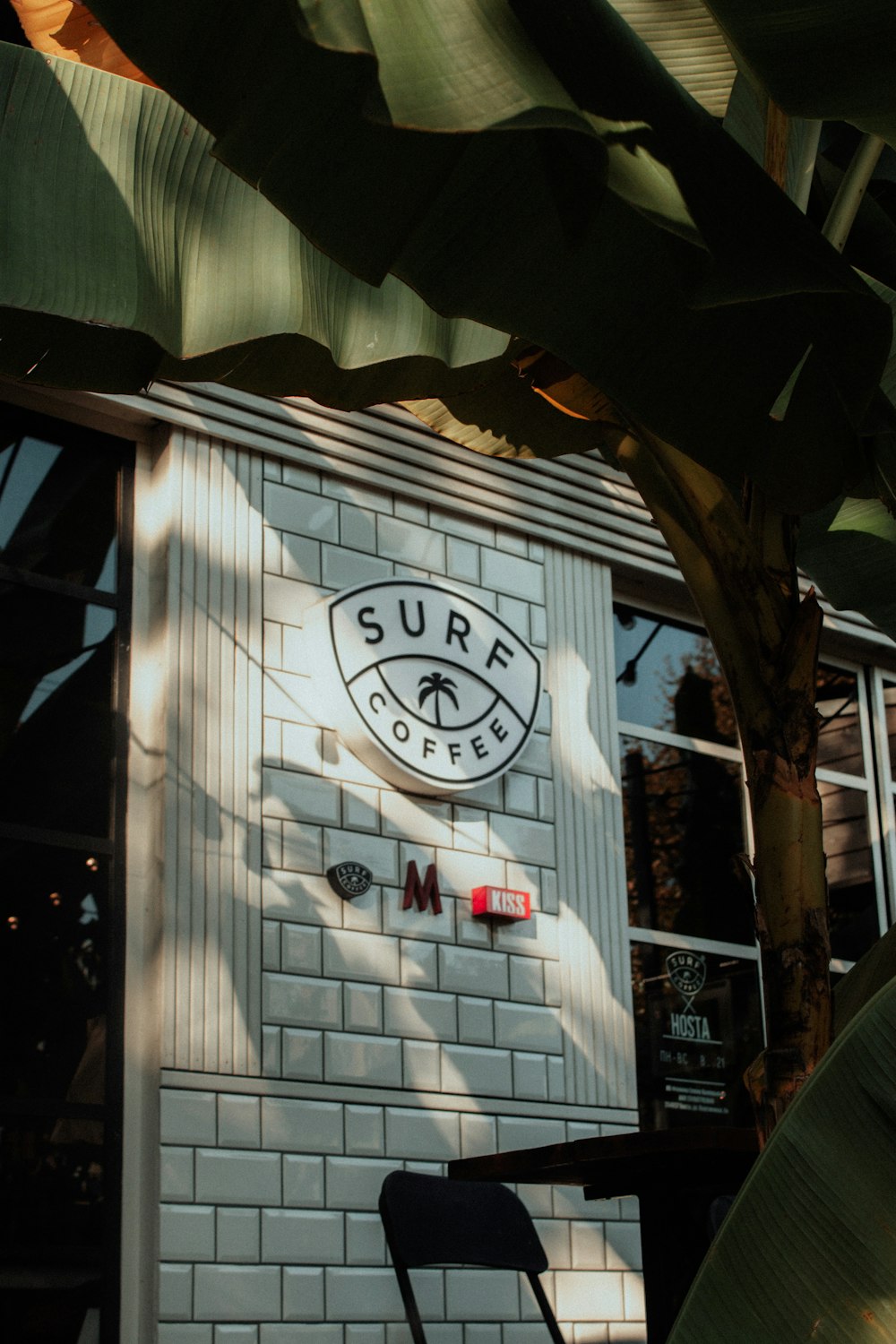 a white brick building with a surf coffee sign on it