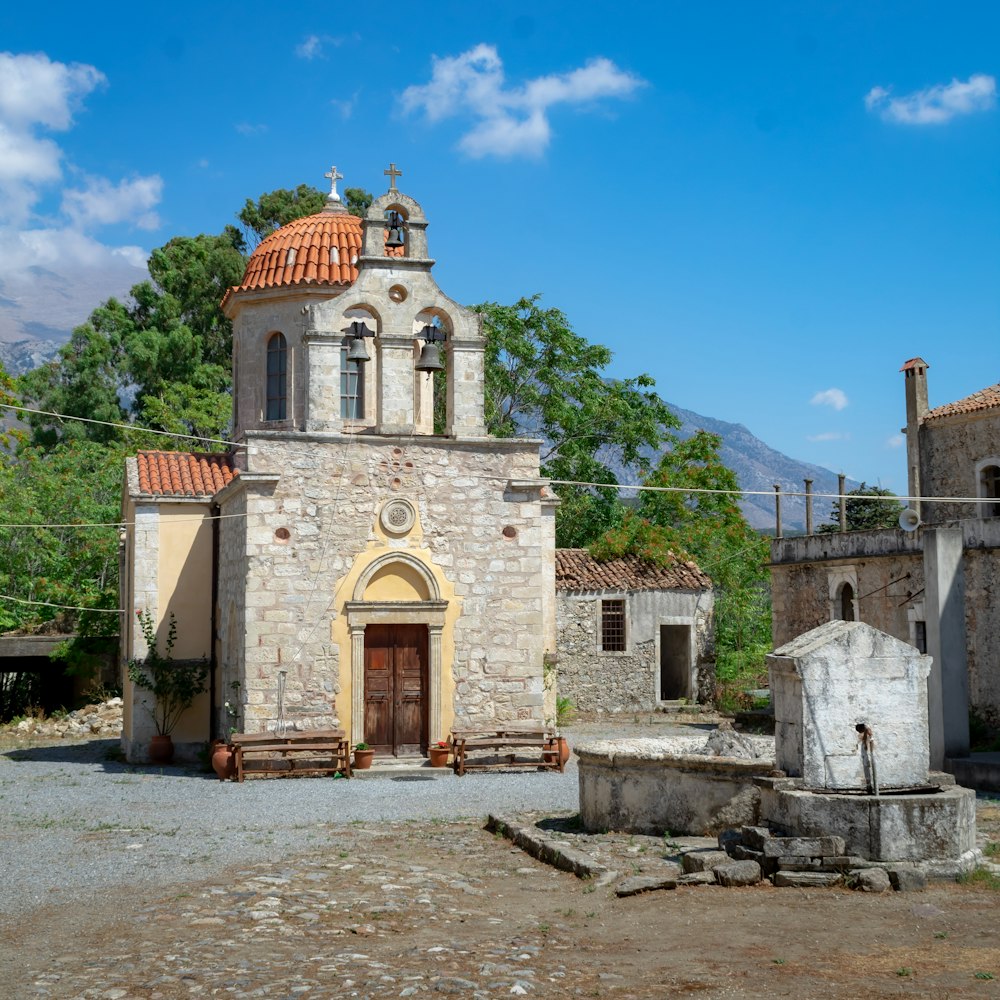 an old stone church with a red roof