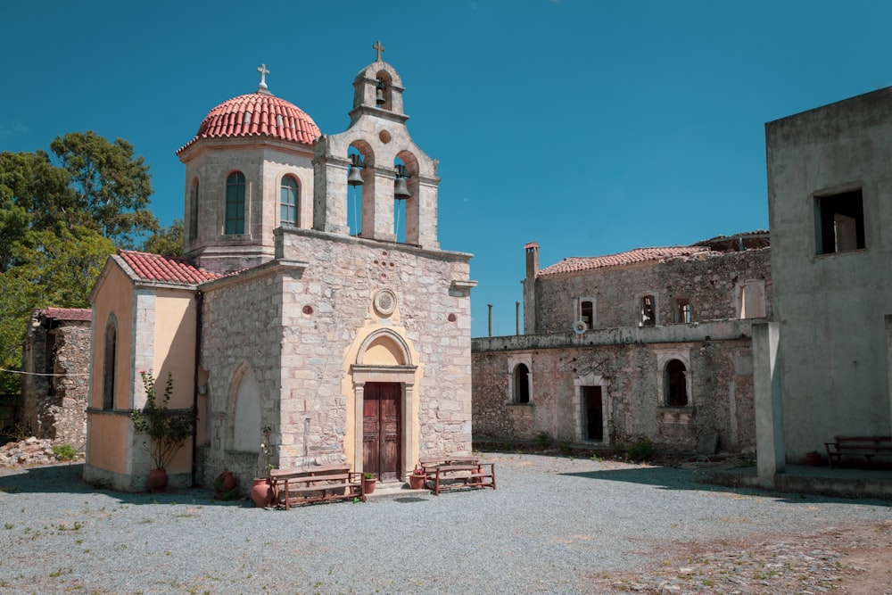 an old church with a red roof and a red and white roof