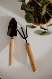 a couple of black spatulas sitting on top of a white plate