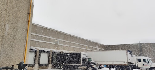Cold storage truck parked at a loading dock with frost on the doors.