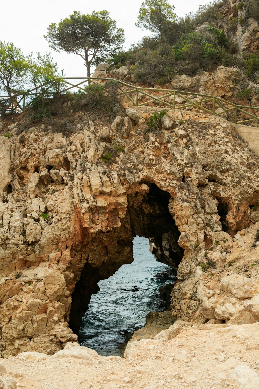 a rocky cliff with a body of water in the middle