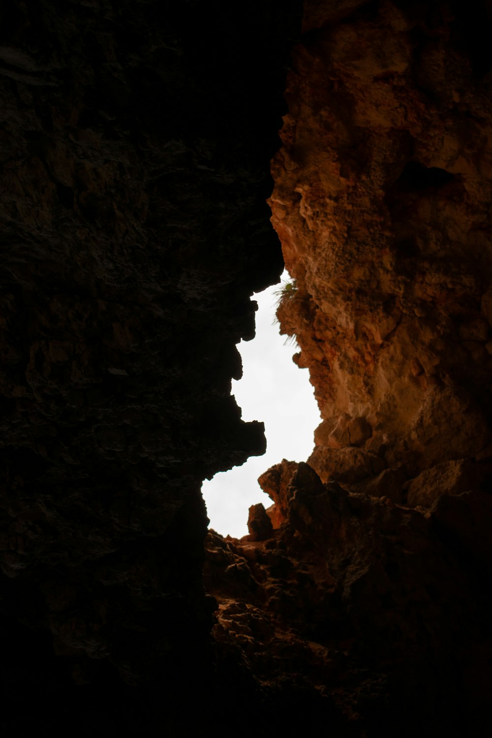 a view of the sky from inside a cave