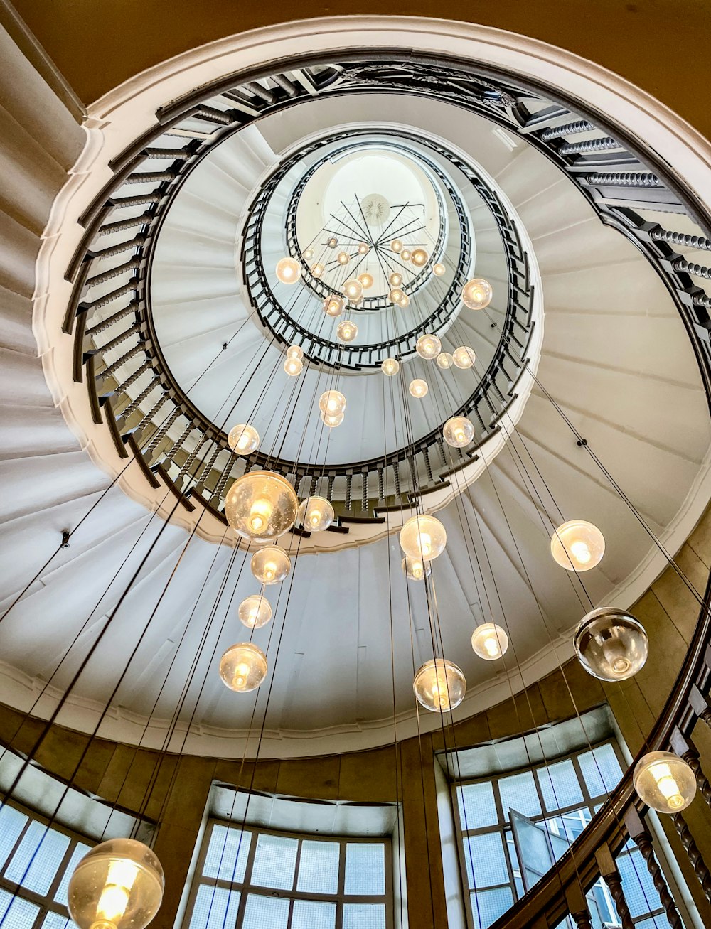 a spiral staircase in a building with lots of windows