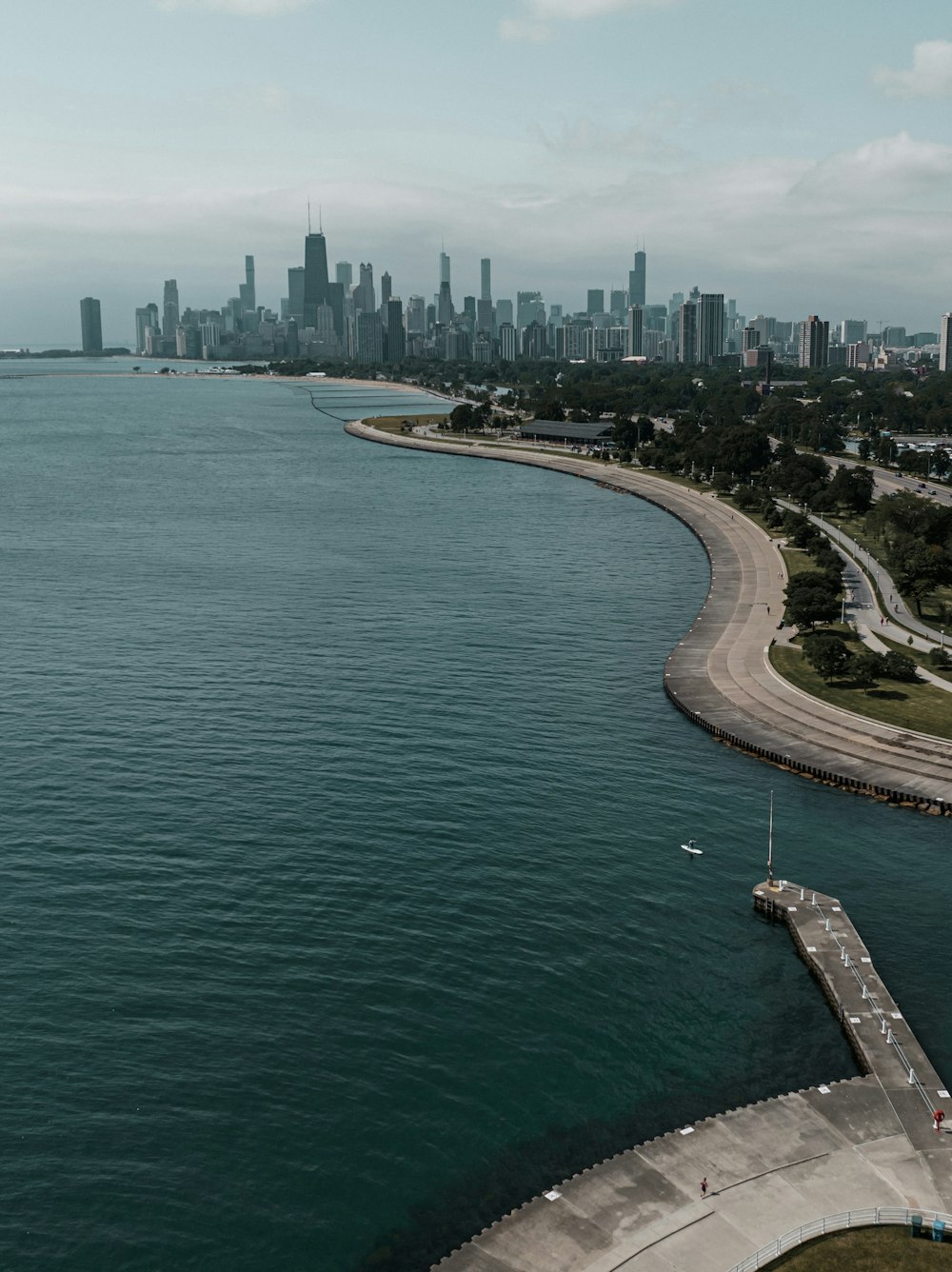 a large body of water with a city in the background