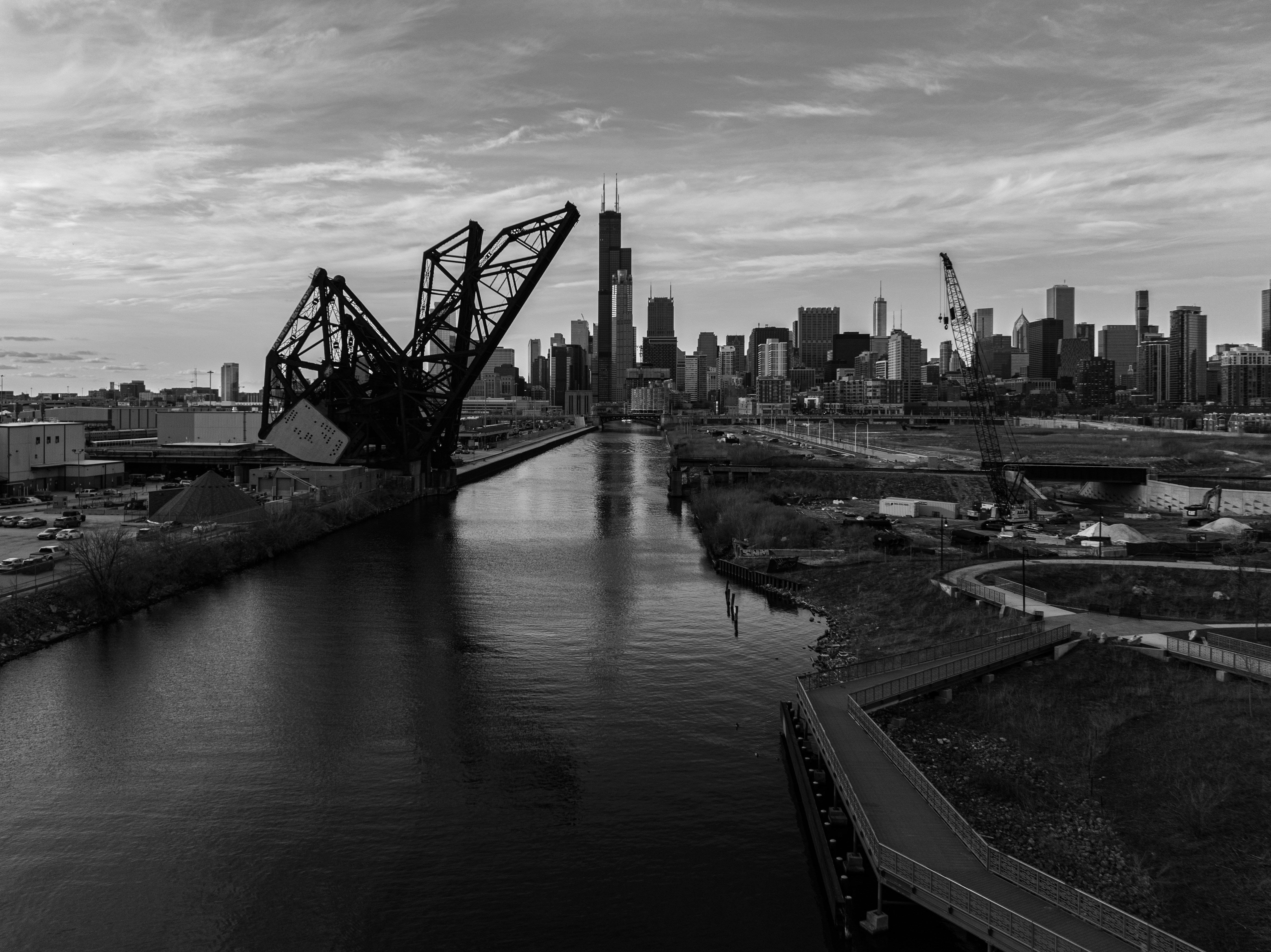 a black and white photo of a bridge over a river