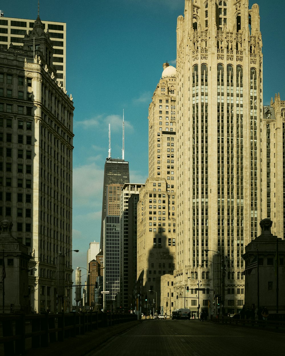 a city street with tall buildings in the background