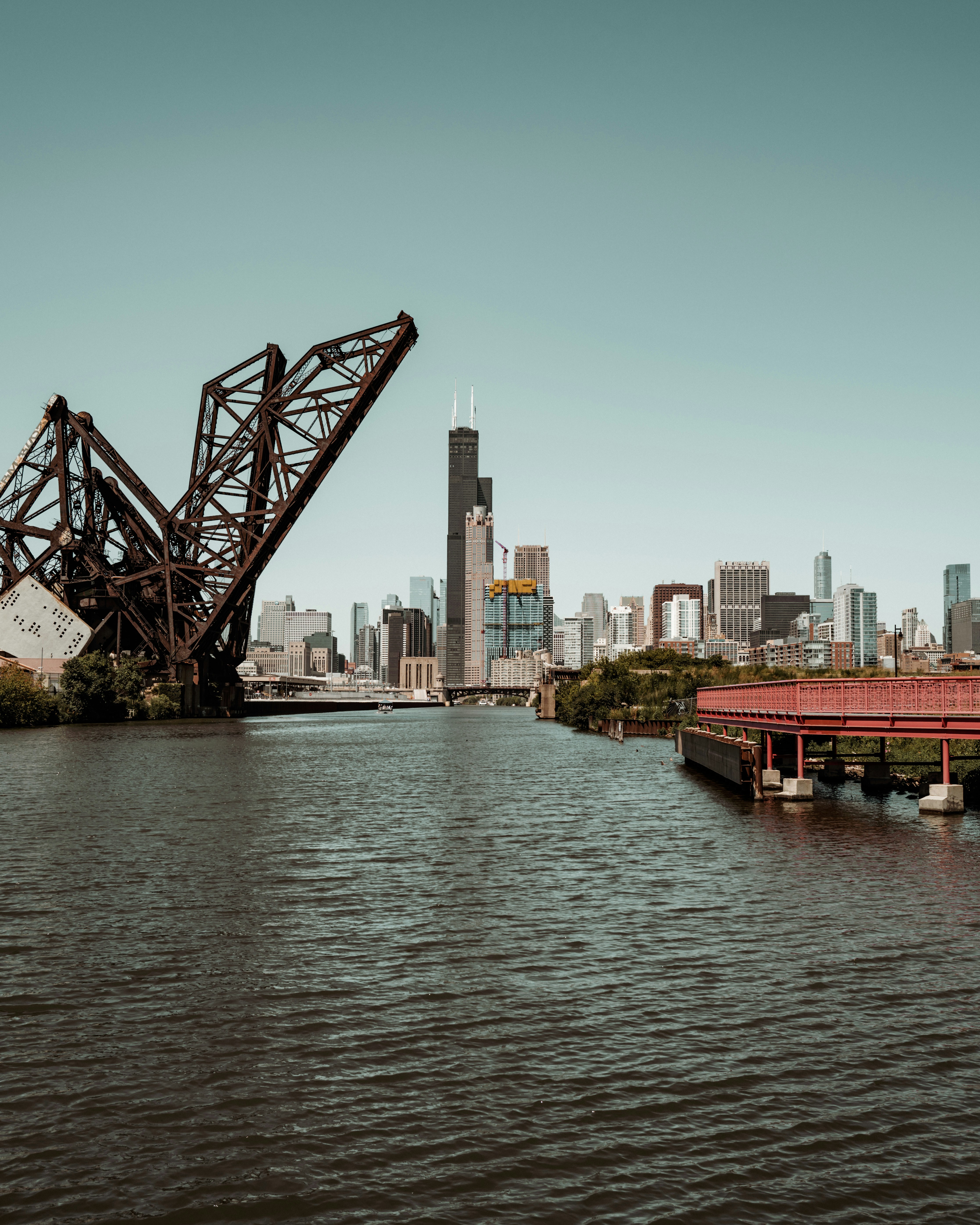 a large bridge over a river with a city in the background