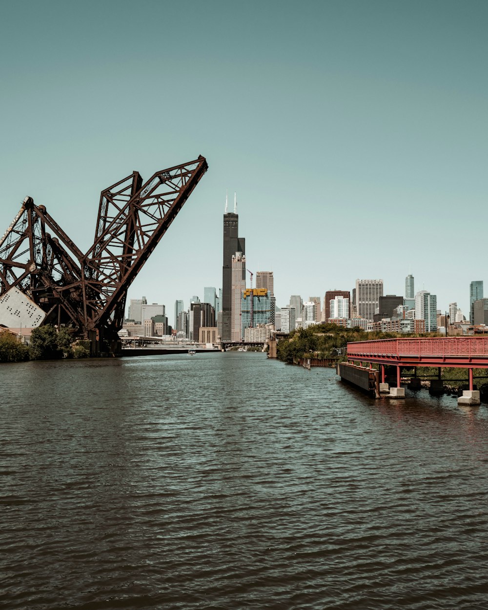 a large bridge over a river with a city in the background