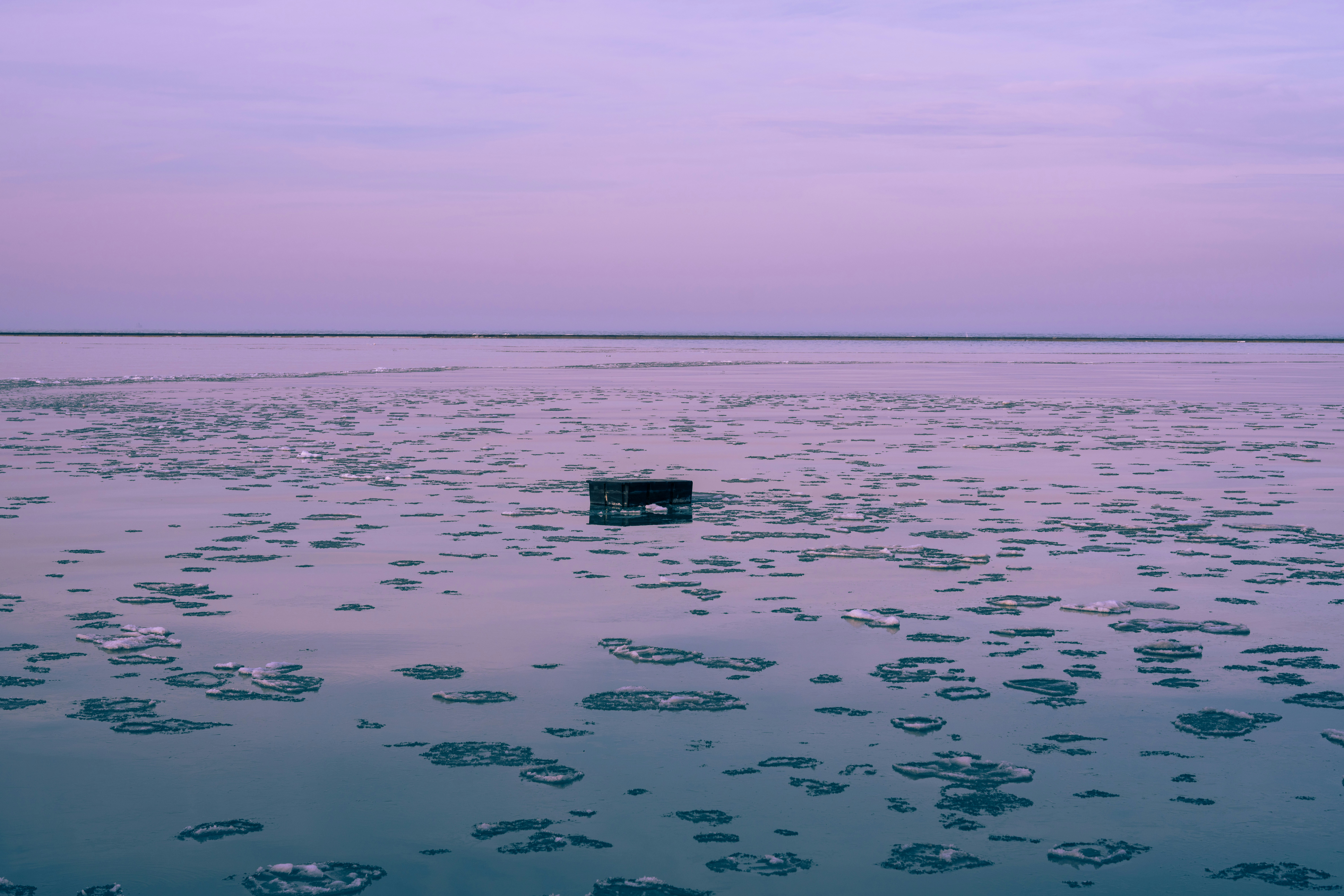 a square object floating in the middle of a body of water