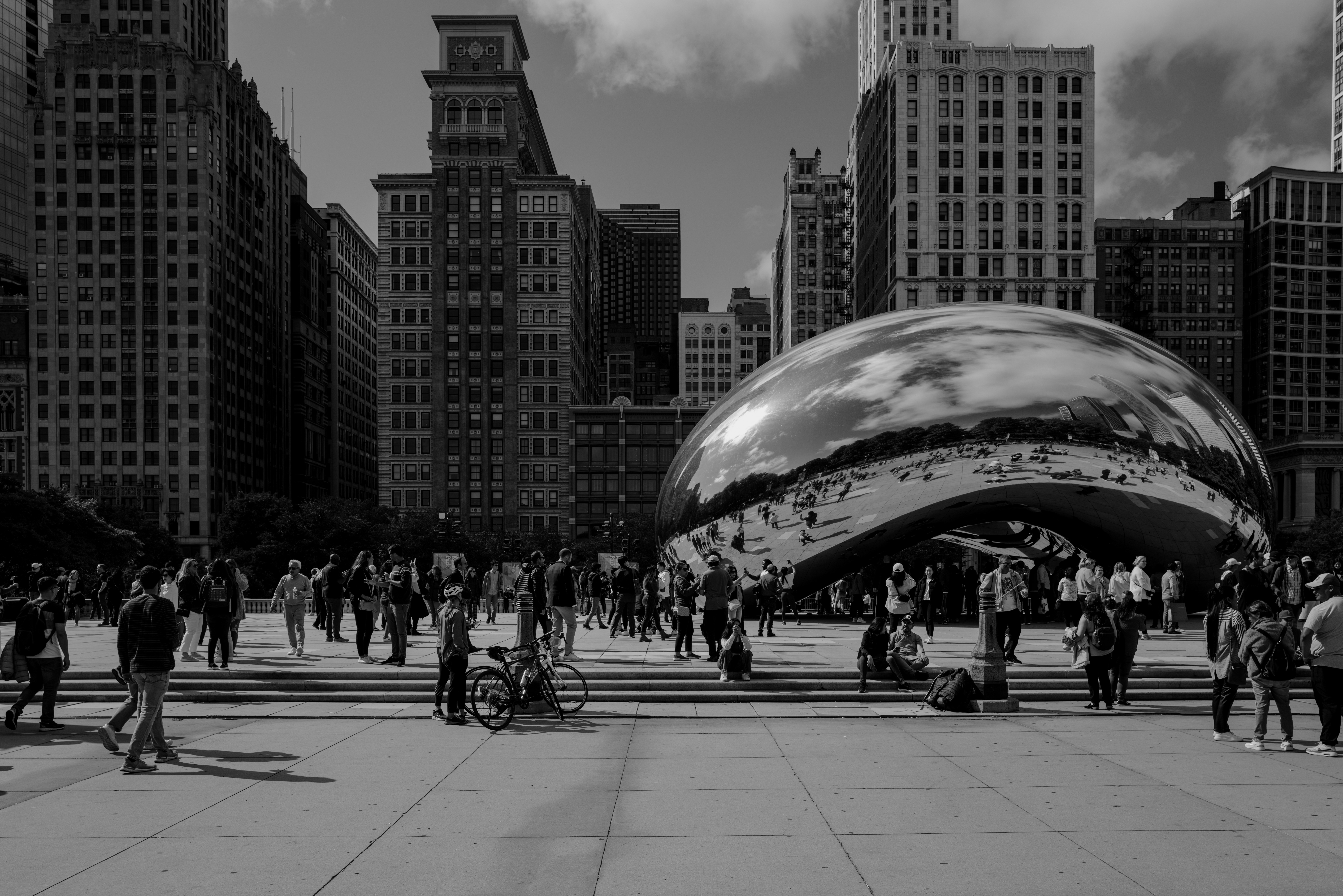 a group of people standing around a large shiny object