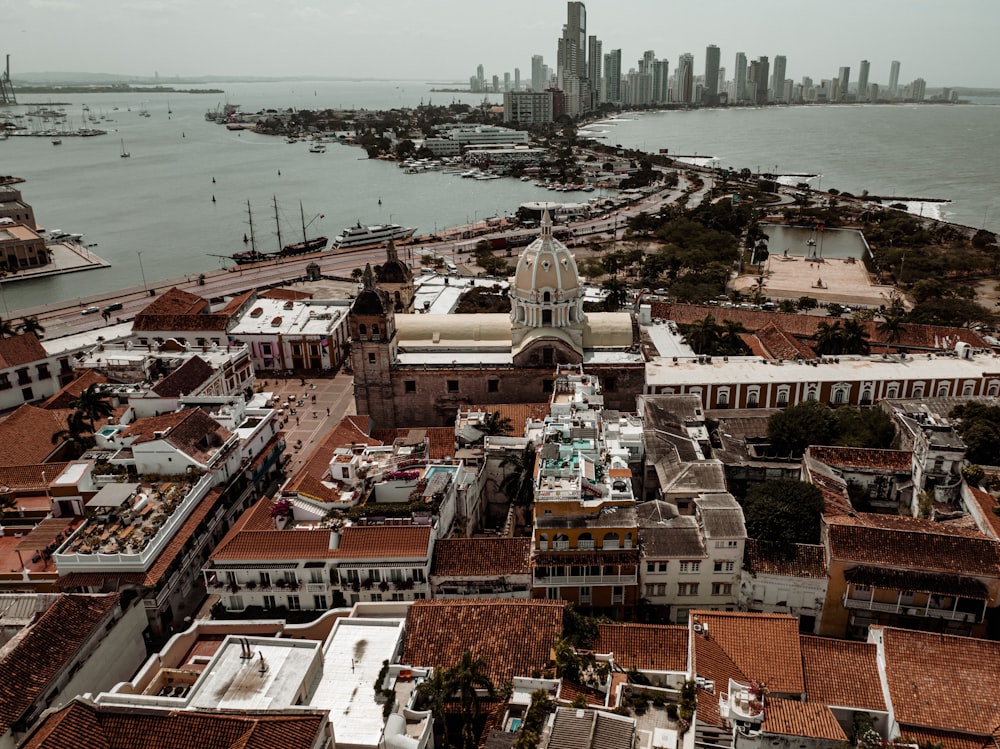 an aerial view of a city with a large body of water