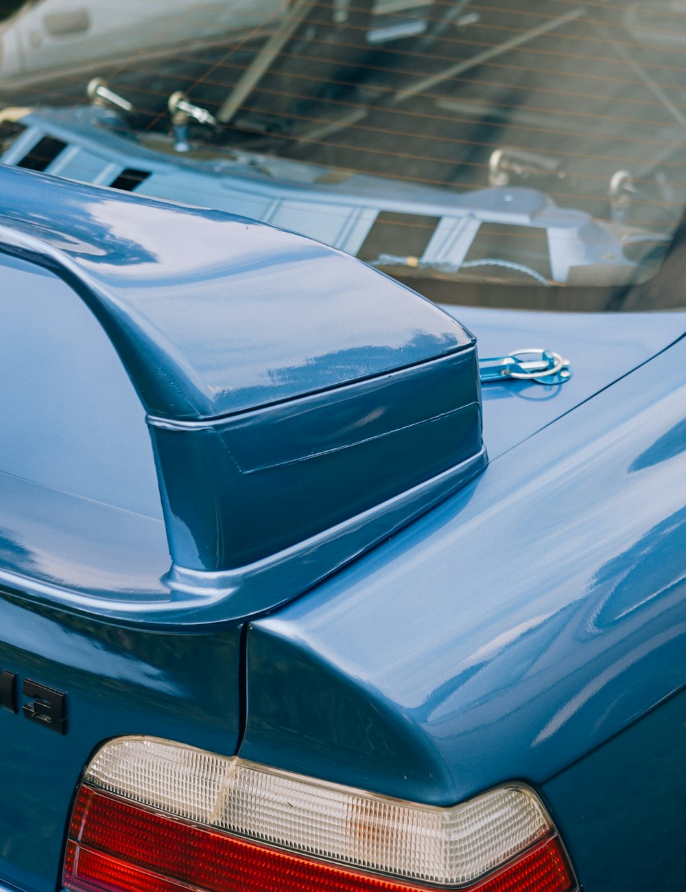 a blue car parked next to a parking meter