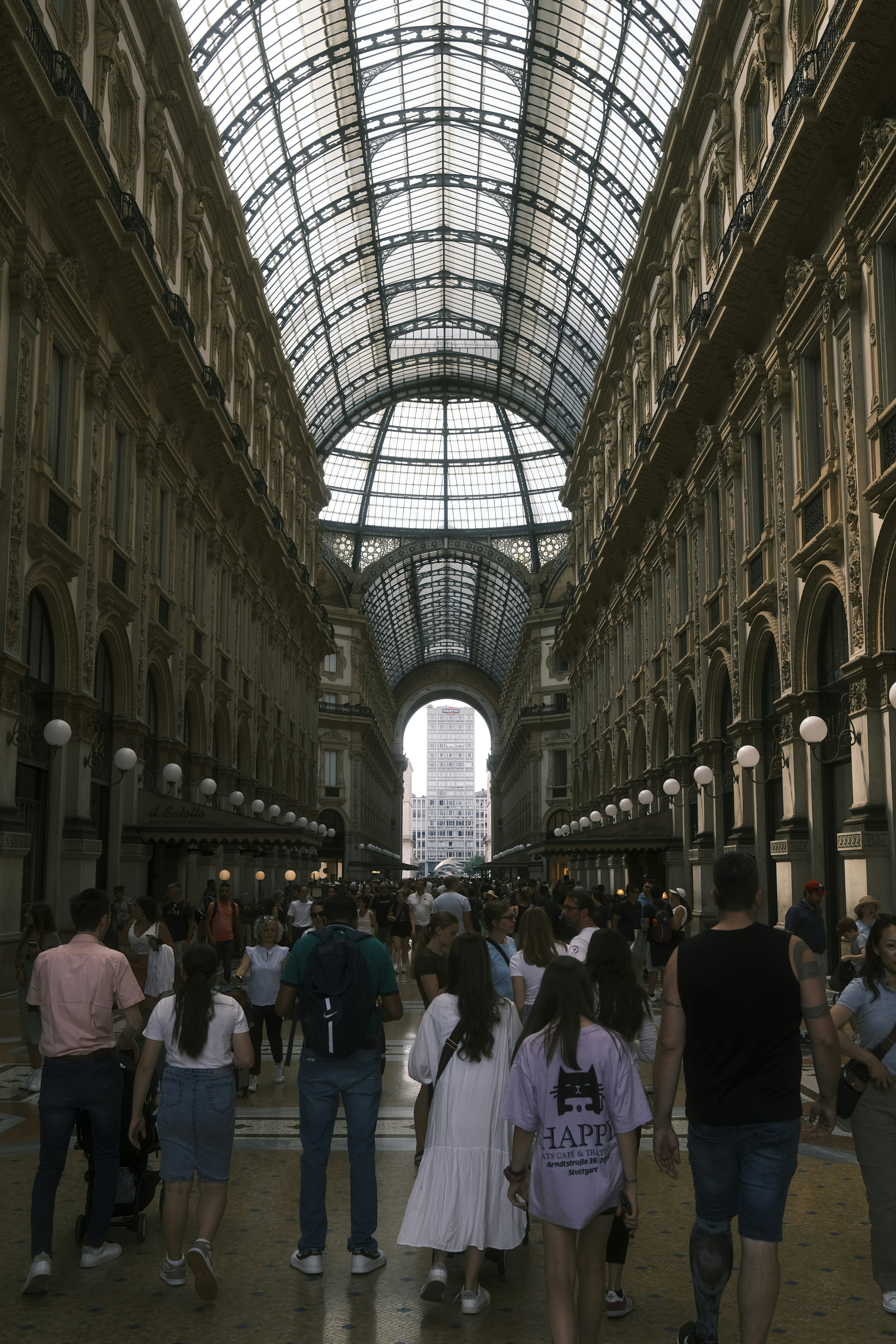 a group of people walking through a large building