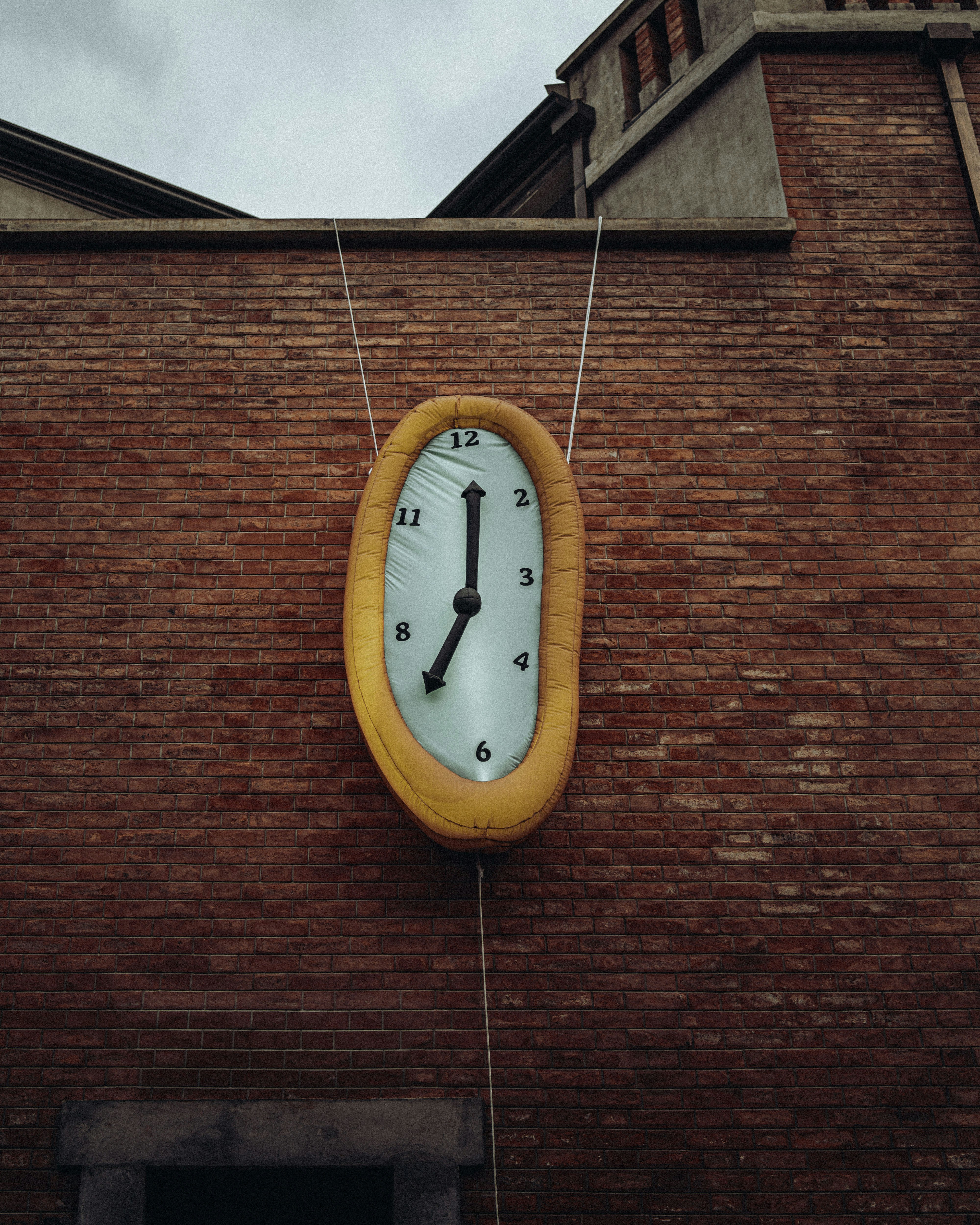 a clock on the side of a brick building