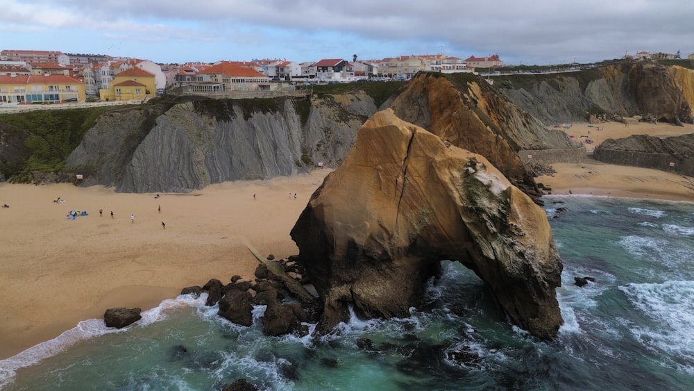 an aerial view of a beach with people walking on it