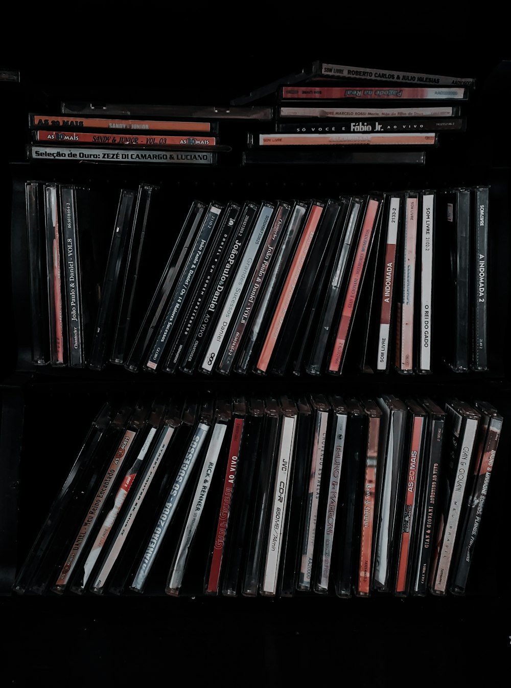a black shelf with a bunch of cds on it