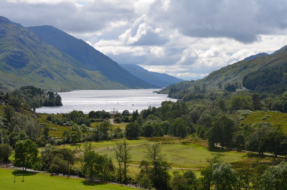 a scenic view of a lake surrounded by mountains