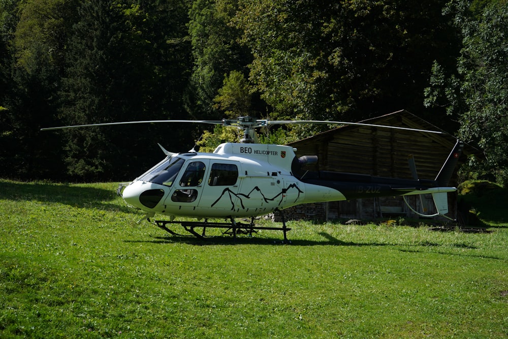 a helicopter sitting on top of a lush green field
