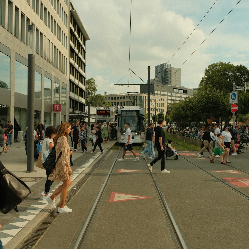 a group of people walking across a street