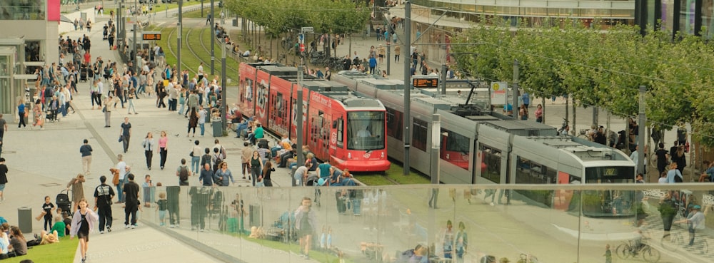 a crowd of people walking around a train station