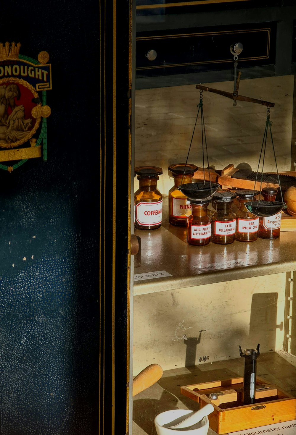 jars of honey sit on a shelf in a kitchen