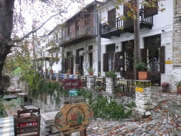 A quaint café terrace in a charming Portuguese village with cobblestone streets.