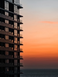 a tall building next to a body of water
