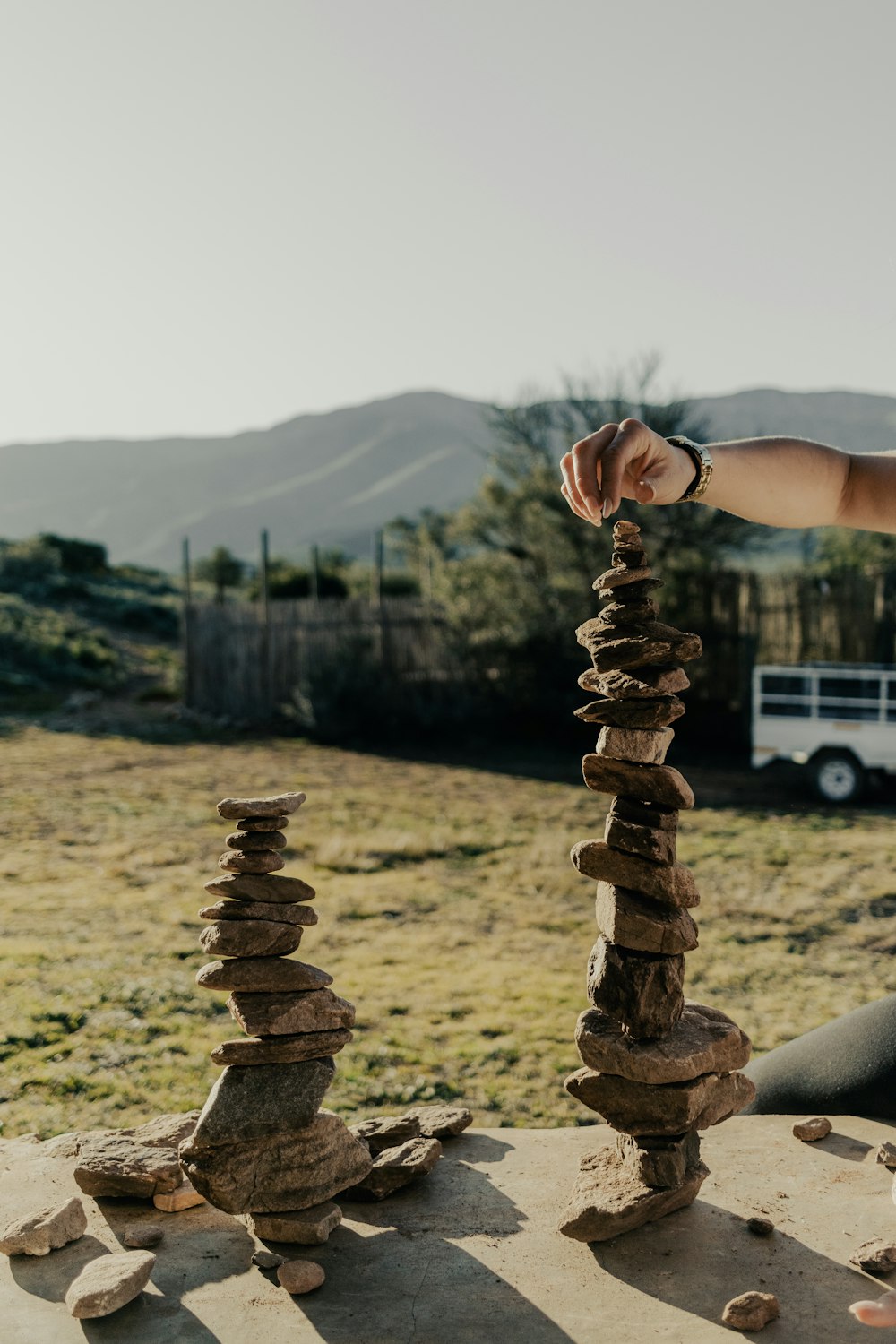 a person stacking rocks on top of each other