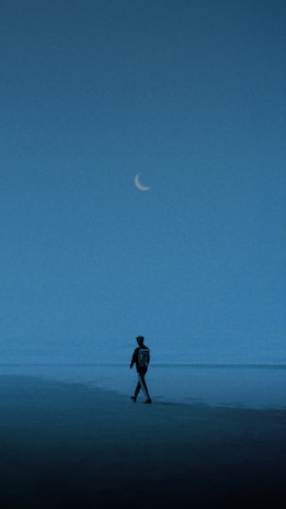 A casual outfit featuring a lunar phases shirt worn during a twilight beach walk.